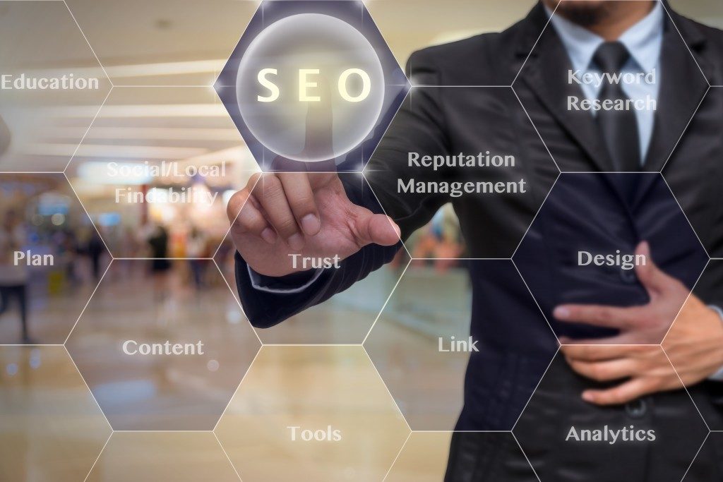 businessman pointing at SEO concept