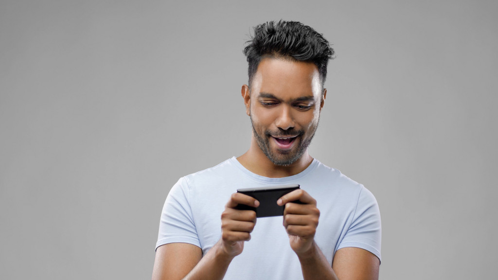 a man playing mobile game